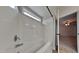 Bathroom with a soaking tub with shower attachment and a partial view into the adjacent bedroom at 300 Nelson Ln, Clayton, NC 27527
