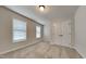 Bedroom with carpet flooring, double windows, and a double door closet for storage at 300 Nelson Ln, Clayton, NC 27527