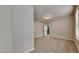 Well-lit bedroom with carpet, window, and an open doorway to the hallway at 300 Nelson Ln, Clayton, NC 27527