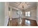 Spacious living room with beautiful hardwood floors, coffered ceilings, and modern lighting fixtures at 300 Nelson Ln, Clayton, NC 27527