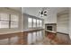 Bright living room featuring hardwood floors, large windows, a stone fireplace, and built-in shelving at 300 Nelson Ln, Clayton, NC 27527