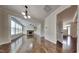 Open floor plan with hardwood floors showcases the kitchen, living, and dining areas with modern fixtures at 300 Nelson Ln, Clayton, NC 27527