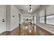Open floor plan with hardwood floors showcases the kitchen, living, and dining areas with modern fixtures at 300 Nelson Ln, Clayton, NC 27527