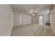 Spacious carpeted main bedroom featuring a ceiling fan, ensuite bathroom, and ample closet space at 300 Nelson Ln, Clayton, NC 27527
