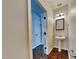 Hallway powder room featuring a pedestal sink, hardwood floors, and modern fixtures at 300 Nelson Ln, Clayton, NC 27527