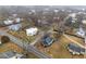 High angle shows house near quiet road with nearby neighborhood, trees and grassy areas at 301 W Hill S Ave, Hillsborough, NC 27278