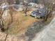 Overhead shot of house and yard, nestled among mature trees, and showing parking area and landscaping at 301 W Hill S Ave, Hillsborough, NC 27278