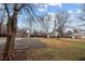 Expansive backyard with a gravel parking area bordered by lush grass, promising endless outdoor opportunities at 301 W Hill S Ave, Hillsborough, NC 27278