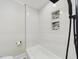 Modern bathroom featuring a tub with white subway tile and built-in mosaic-tiled shelving niche at 301 W Hill S Ave, Hillsborough, NC 27278