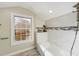 Bathroom with subway tile, showerhead, a window, and a ledge for decor at 301 W Hill S Ave, Hillsborough, NC 27278