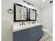 Bathroom with dual sinks and a large mirror at 301 W Hill S Ave, Hillsborough, NC 27278