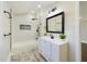 Bathroom featuring a white vanity, shower, and natural light at 301 W Hill S Ave, Hillsborough, NC 27278