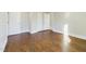 A bedroom featuring hardwood floors, white trim, and white doors at 301 W Hill S Ave, Hillsborough, NC 27278