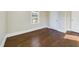 A bedroom featuring hardwood floors, white trim, and white doors at 301 W Hill S Ave, Hillsborough, NC 27278