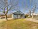 Charming exterior view showcasing a cozy home with well-maintained lawn and mature trees at 301 W Hill S Ave, Hillsborough, NC 27278
