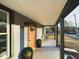 Covered front porch with seating, a welcoming entrance, and well-manicured landscaping at 301 W Hill S Ave, Hillsborough, NC 27278