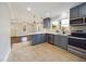 Stylish kitchen featuring gray cabinets, stainless steel appliances, and an open layout at 301 W Hill S Ave, Hillsborough, NC 27278