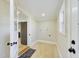 Clean laundry room with neutral paint, tile flooring, and a window at 301 W Hill S Ave, Hillsborough, NC 27278