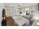 Bright living room with large windows, neutral walls, hardwood floors, and comfortable modern seating at 301 W Hill S Ave, Hillsborough, NC 27278