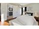 The main bedroom features blue drapes, and an ensuite bathroom with a gray vanity and light flooring at 301 W Hill S Ave, Hillsborough, NC 27278