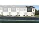 Modern townhome with a two-car garage and lush green lawn at 3019 Vitner Dr, Durham, NC 27704