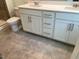 Bathroom features double sink vanity with white cabinetry and tile flooring at 3019 Vitner Dr, Durham, NC 27704