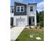 Inviting townhome boasts manicured lawn, modern design, and charming curb appeal at 3019 Vitner Dr, Durham, NC 27704