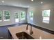 Kitchen boasts large island with sink, modern faucet, and pendant lights at 3019 Vitner Dr, Durham, NC 27704