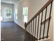 Staircase boasts natural wood stairs with modern black metal spindles at 3019 Vitner Dr, Durham, NC 27704