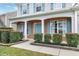 Charming home exterior featuring a brick facade, light blue door and shutters, and manicured landscaping at 303 Shakespeare St, Morrisville, NC 27560