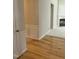 Hallway with wainscoting detail and wood floors leads to a spacious living area with fireplace at 3108 Fortress Gate Dr, Raleigh, NC 27614