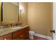 Bathroom features a granite countertop and wooden vanity at 3605 Camp Mangum Wynd, Raleigh, NC 27612