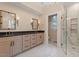 Elegant bathroom featuring a double vanity, modern mirrors, and a walk-in shower at 3605 Camp Mangum Wynd, Raleigh, NC 27612