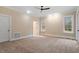 Bright bedroom with neutral walls, carpet, windows and a ceiling fan at 3605 Camp Mangum Wynd, Raleigh, NC 27612