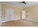 Cozy bedroom features carpet, closet, neutral walls, and a ceiling fan at 3605 Camp Mangum Wynd, Raleigh, NC 27612