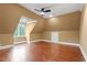 Bedroom featuring hardwood floors, ceiling fan and an attic window at 3605 Camp Mangum Wynd, Raleigh, NC 27612