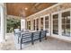 Stylish covered patio with brick pillars, wood ceiling, ceiling fans, and comfortable seating, perfect for outdoor entertaining at 3605 Camp Mangum Wynd, Raleigh, NC 27612