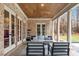 Inviting covered patio featuring a wood ceiling, brick columns, and comfortable seating for outdoor relaxation at 3605 Camp Mangum Wynd, Raleigh, NC 27612