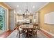 An elegant dining area showcasing a round table, hardwood floors, and classic lighting at 3605 Camp Mangum Wynd, Raleigh, NC 27612