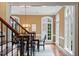 Staircase view of the dining room featuring hardwood floors, a chandelier, and abundant natural light at 3605 Camp Mangum Wynd, Raleigh, NC 27612
