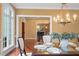 Cozy dining room illuminated by a gold chandelier and sunlight at 3605 Camp Mangum Wynd, Raleigh, NC 27612
