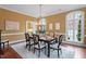 Formal dining room with hardwood floors, large window, and stylish chairs at 3605 Camp Mangum Wynd, Raleigh, NC 27612
