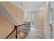 Hallway with wood railing, carpet floors and french doors leading to the balcony at 3605 Camp Mangum Wynd, Raleigh, NC 27612