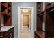 Hallway with dark wood shelves and drawers and a view into another room at 3605 Camp Mangum Wynd, Raleigh, NC 27612