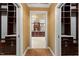 Hallway with carpet, yellow walls, and view into the bathroom at 3605 Camp Mangum Wynd, Raleigh, NC 27612