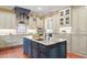 Island kitchen boasts stainless appliances, pendant lights, and ample storage at 3605 Camp Mangum Wynd, Raleigh, NC 27612