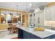 Bright kitchen featuring a marble island, modern lighting fixtures, and stainless steel appliances at 3605 Camp Mangum Wynd, Raleigh, NC 27612