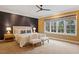 Well-lit main bedroom with a ceiling fan, two chairs, and large windows at 3605 Camp Mangum Wynd, Raleigh, NC 27612