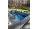 Beautiful backyard pool with an automatic cover, surrounded by lush greenery, offering a refreshing oasis for relaxation at 3605 Camp Mangum Wynd, Raleigh, NC 27612