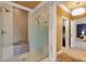 Modern shower with bench, bronze tile accents, and glass enclosure at 3605 Camp Mangum Wynd, Raleigh, NC 27612